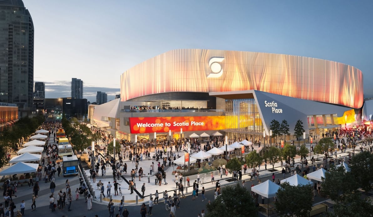 A large arena building with bustling crowds around it.