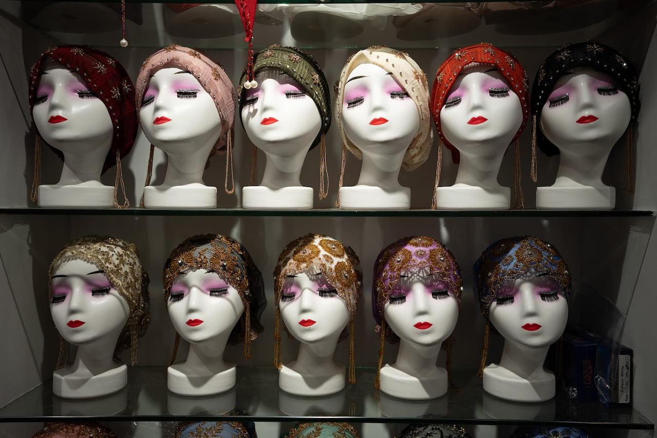 A series of mannequin heads showcasing headcoverings aimed at the Muslim market.