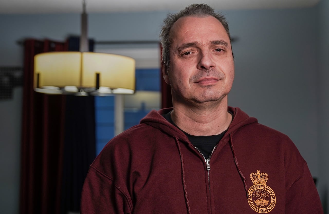 A man in a burgundy hoodie.