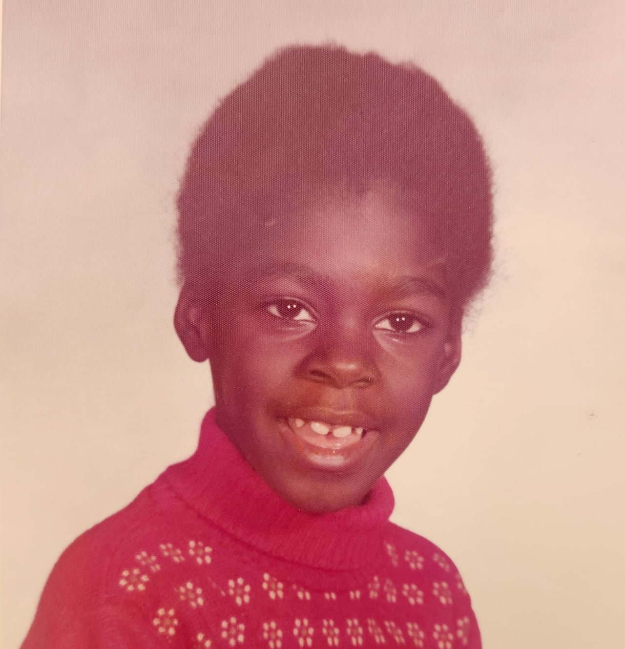 Little girl in a red sweater.