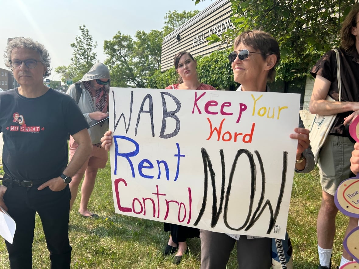 A group of people are on a field holding signs.