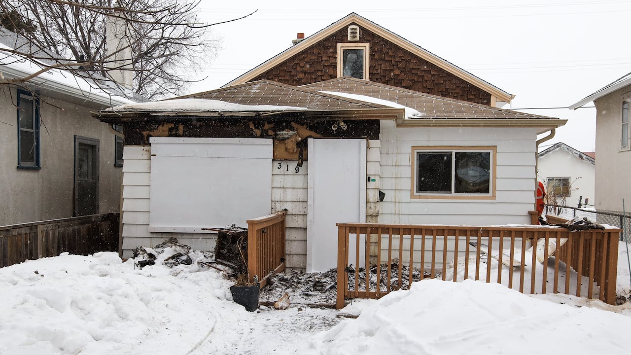 A small home is seen from the outside in winter