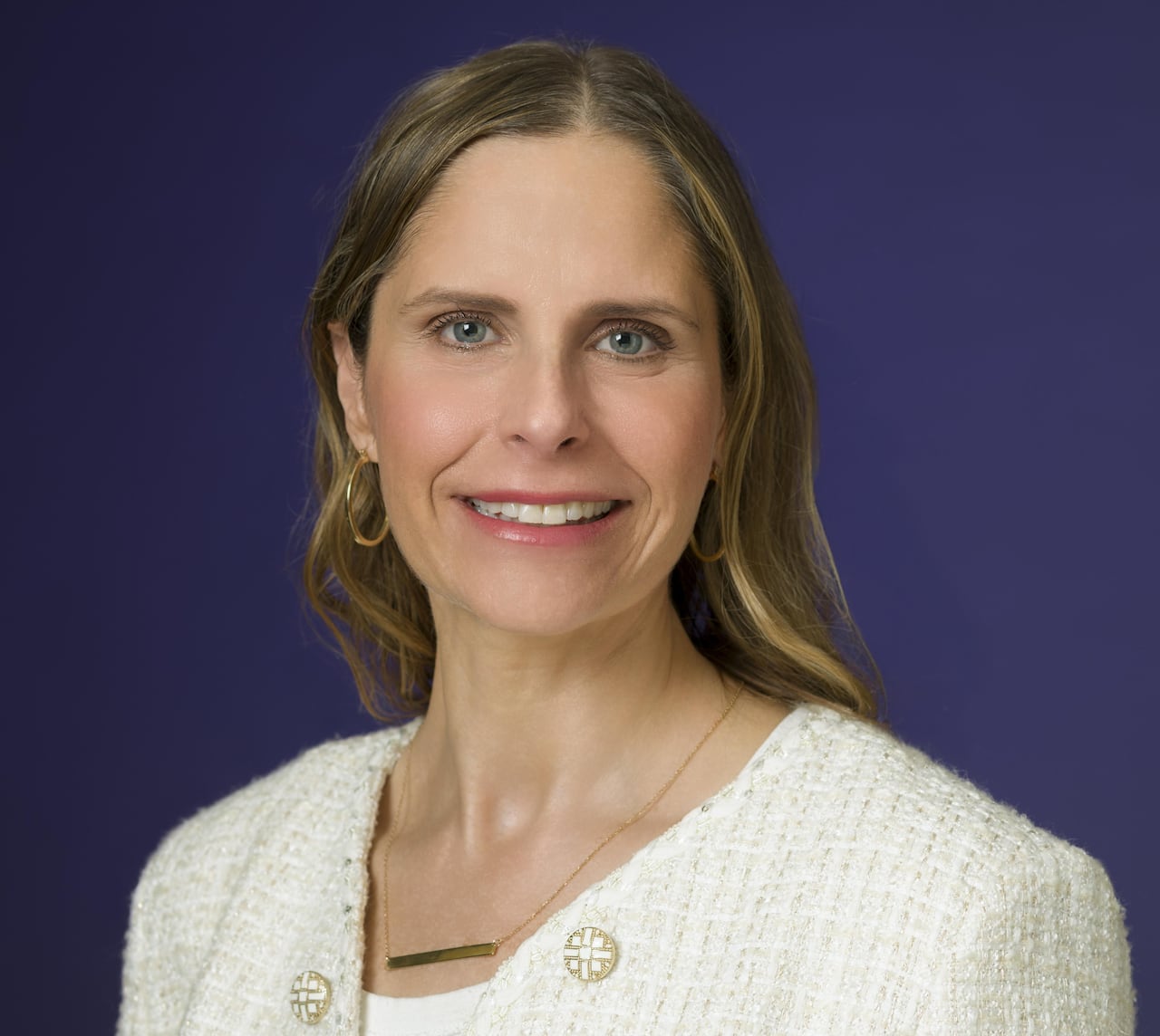 A woman smiles in a headshot photo. 
