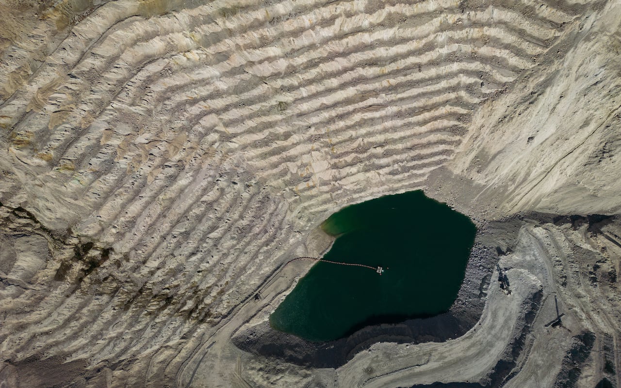 Aerial view of a terraced open-pit copper mine. 