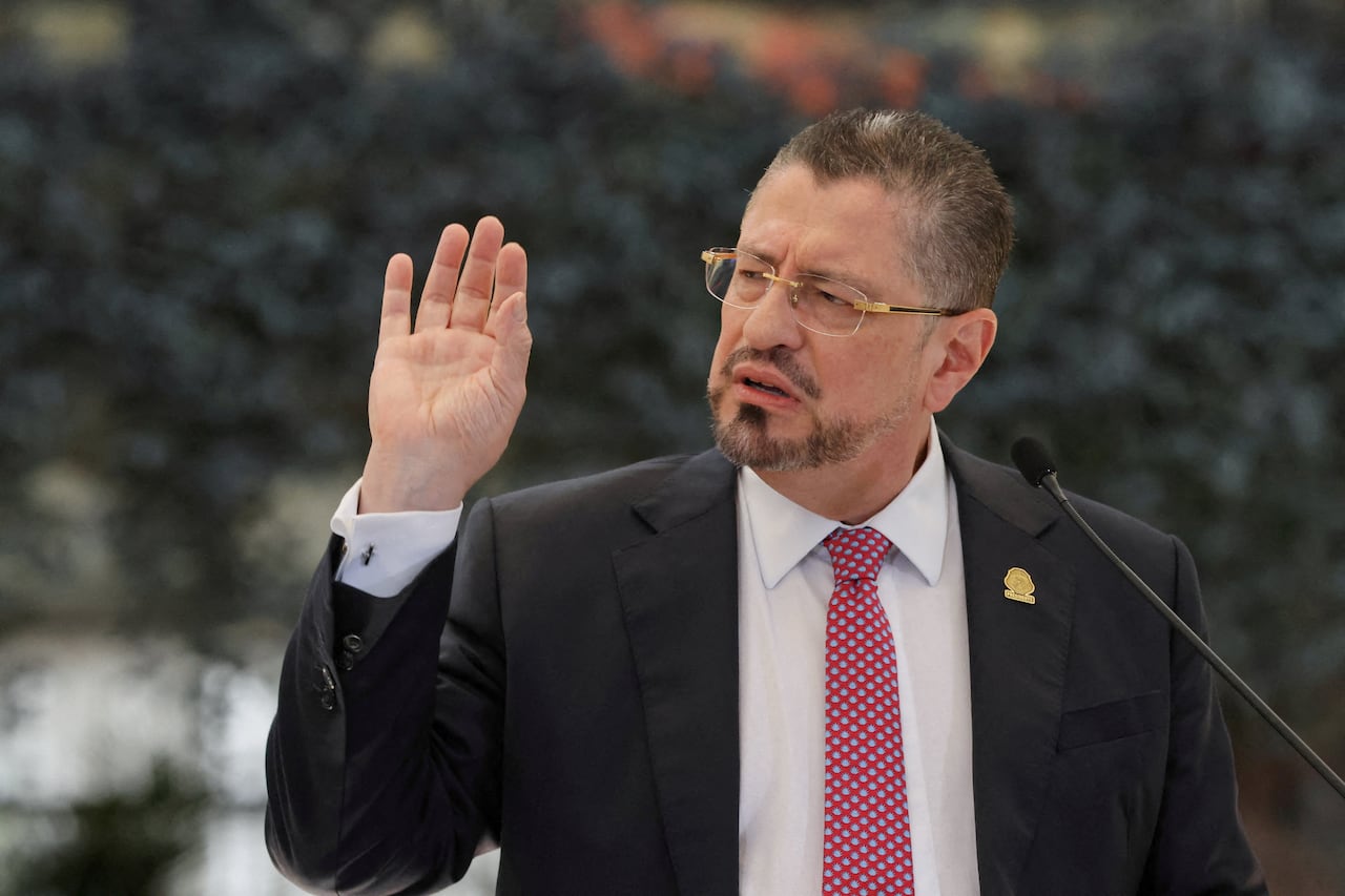 Man in a suit and tie gesturing as he speaks