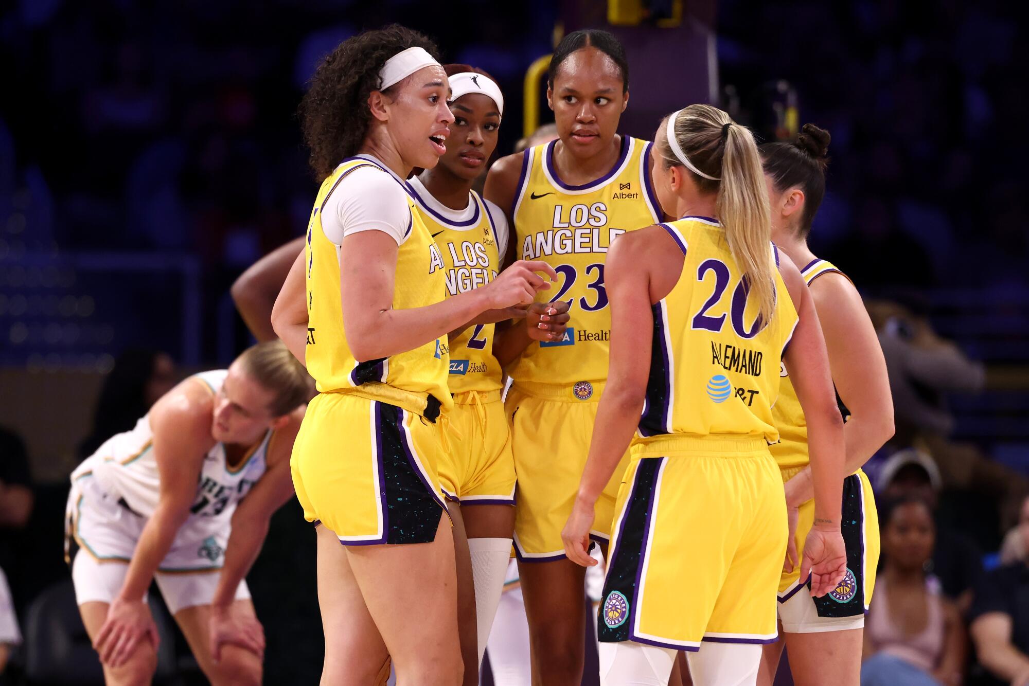 Sparks players Dearica Hamby, Rickea Jackson, Azura Stevens, Kelsey Plum and Julie Allemand talk during a game.