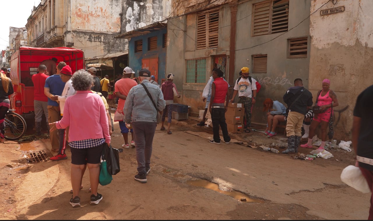 People stand near an entrance on a street.