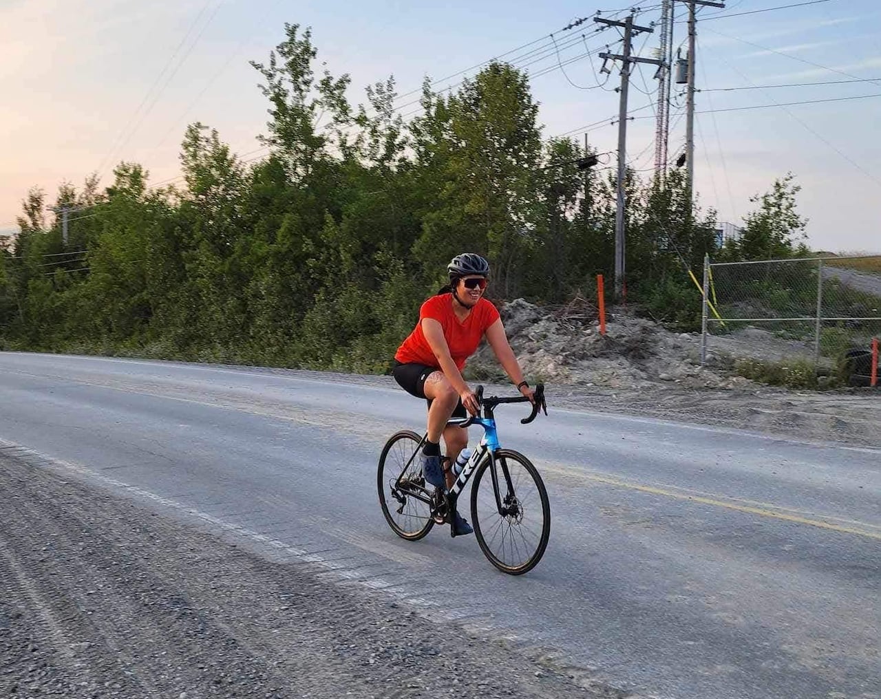 A cyclist on paved road. 