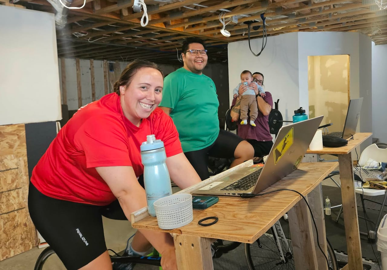Two cyclists training indoors