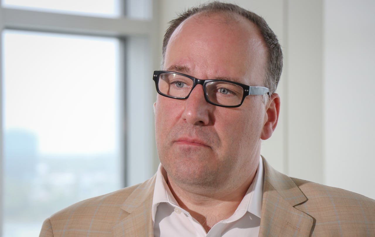 A balding man with glasses is shown.