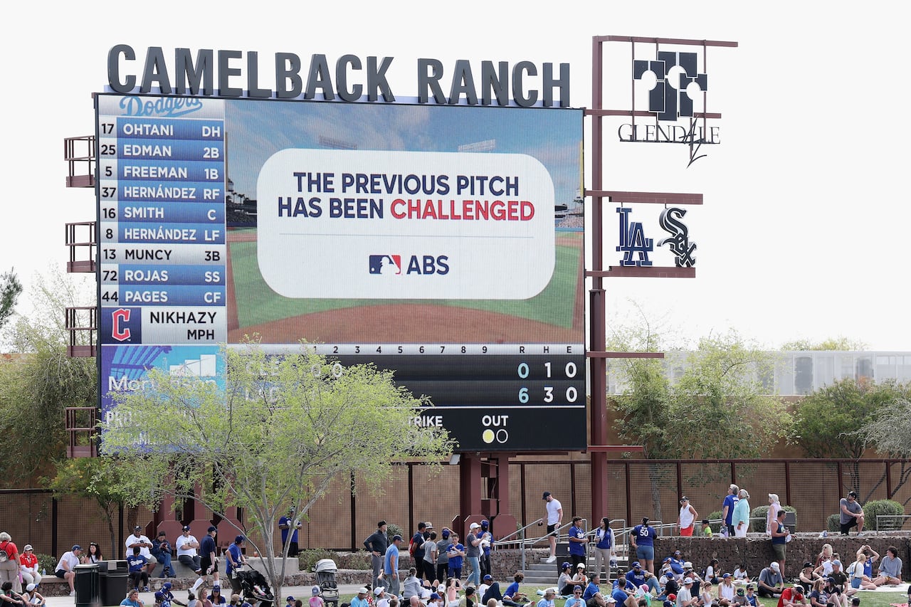 A video board tells fans at a spring training game that a call at the plate is being challenged via MLB's ABS Challenge System