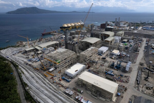 The Ilijan liquified natural gas plant is visible with Verde Island, in the distance, along the coast of Ilijan, Batangas province, Philippines on Aug. 11, 2023. (AP Photo/Aaron Favila, File)