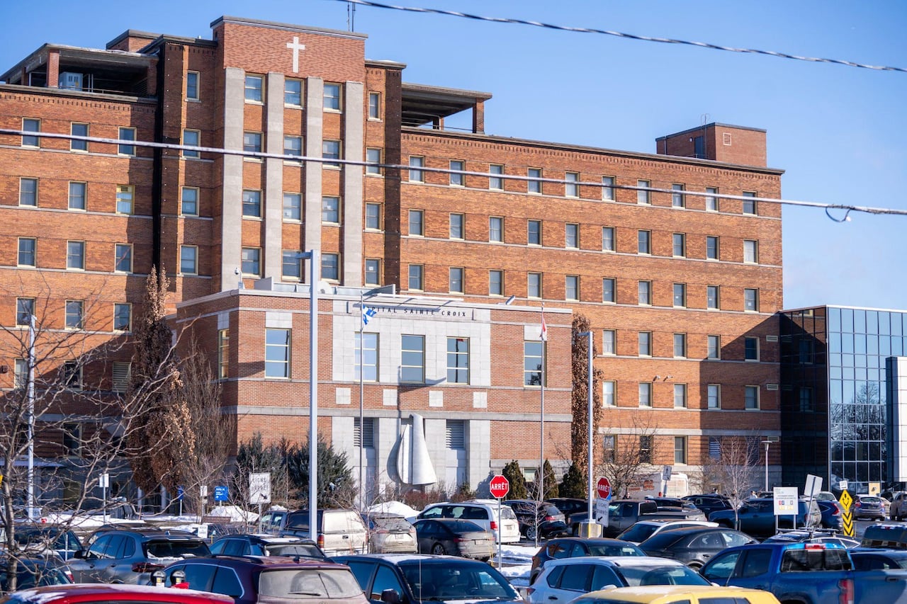 A brick building with a cross on the front
