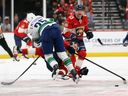 Vancouver Canucks defenceman Elias Pettersson crushes Jesper Boqvist of the Florida Panthers during a Nov. 17 game in Sunrise, Fla.