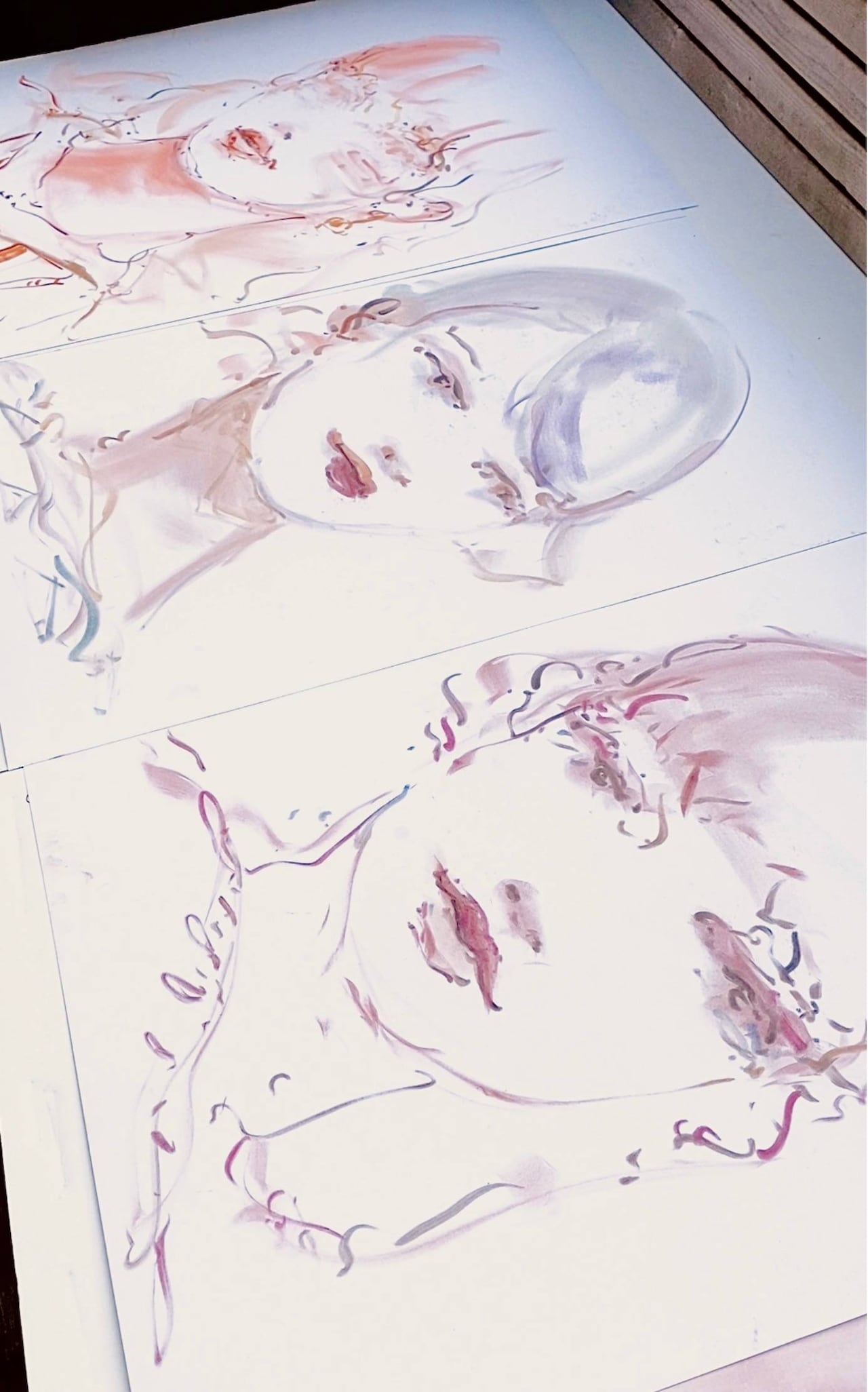 Three sketched portraits of modelesque women in a loose, gestural style. They appear side by side, drawn on white paper with reddish pigment.