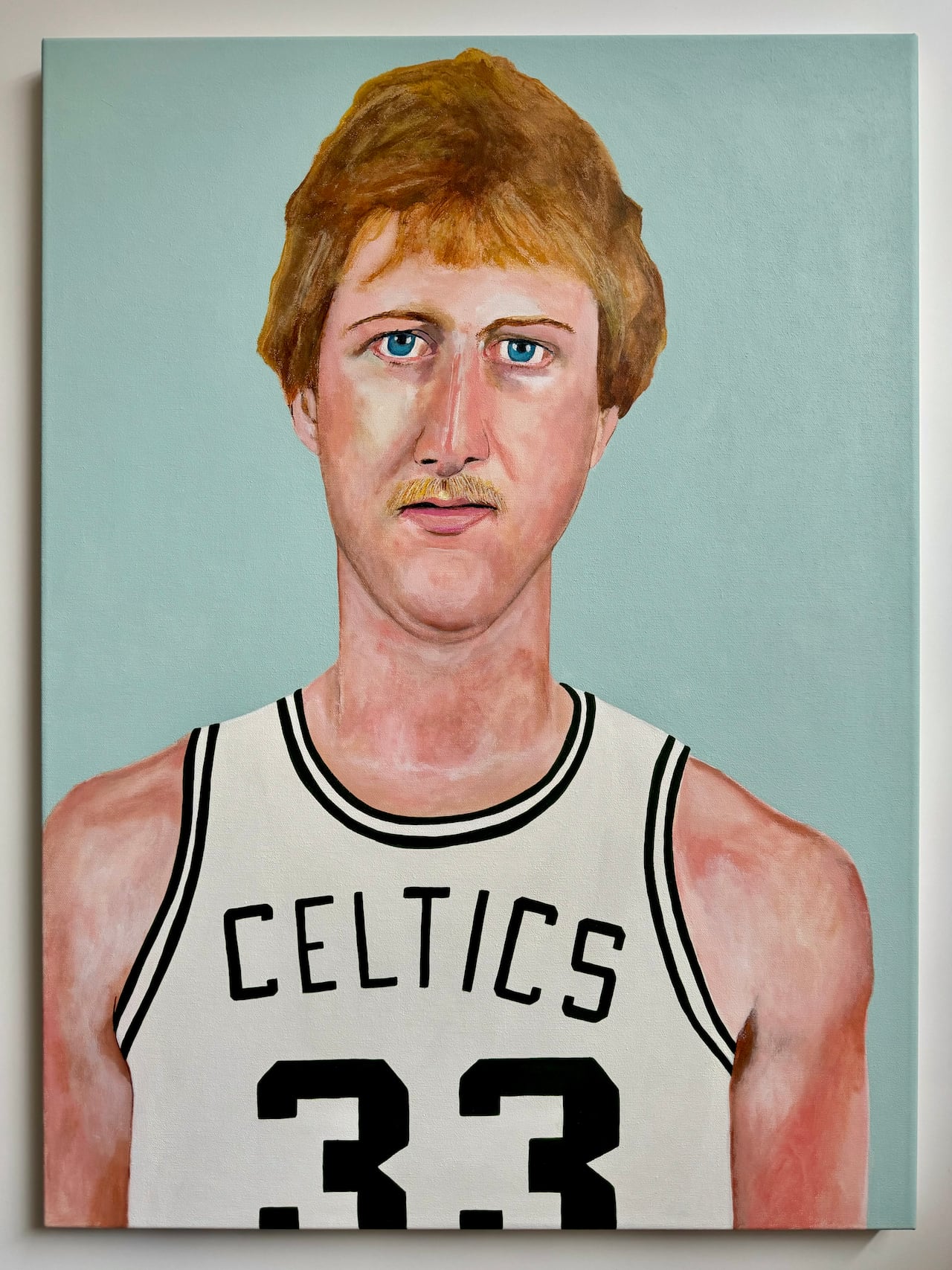 Painted portrait of basketball player Larry Bird, a blonde man with a moustache wearing a basketball uniform. It is rendered in a style reminiscent of folk art. Bird's proportions are slightly askew, lending the portrait an expressive quality.