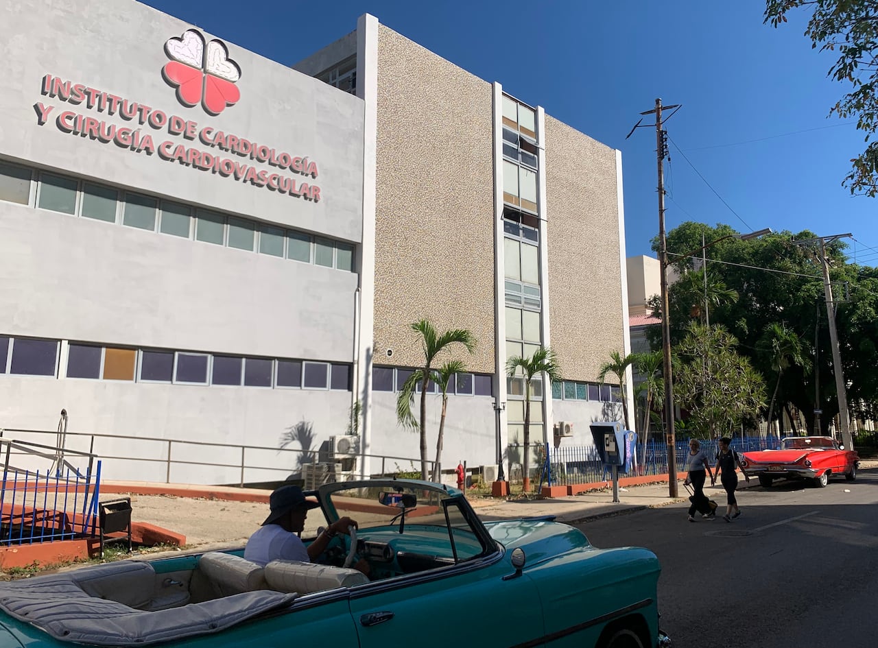 a car passes by in front of a hospital 