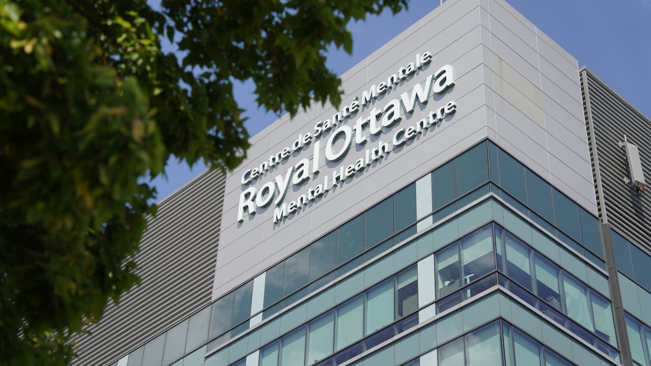 A photo of the exterior of a large blue building. There's a sign on the side of the building that reads "Royal Ottawa Mental Health Centre" in English and French.