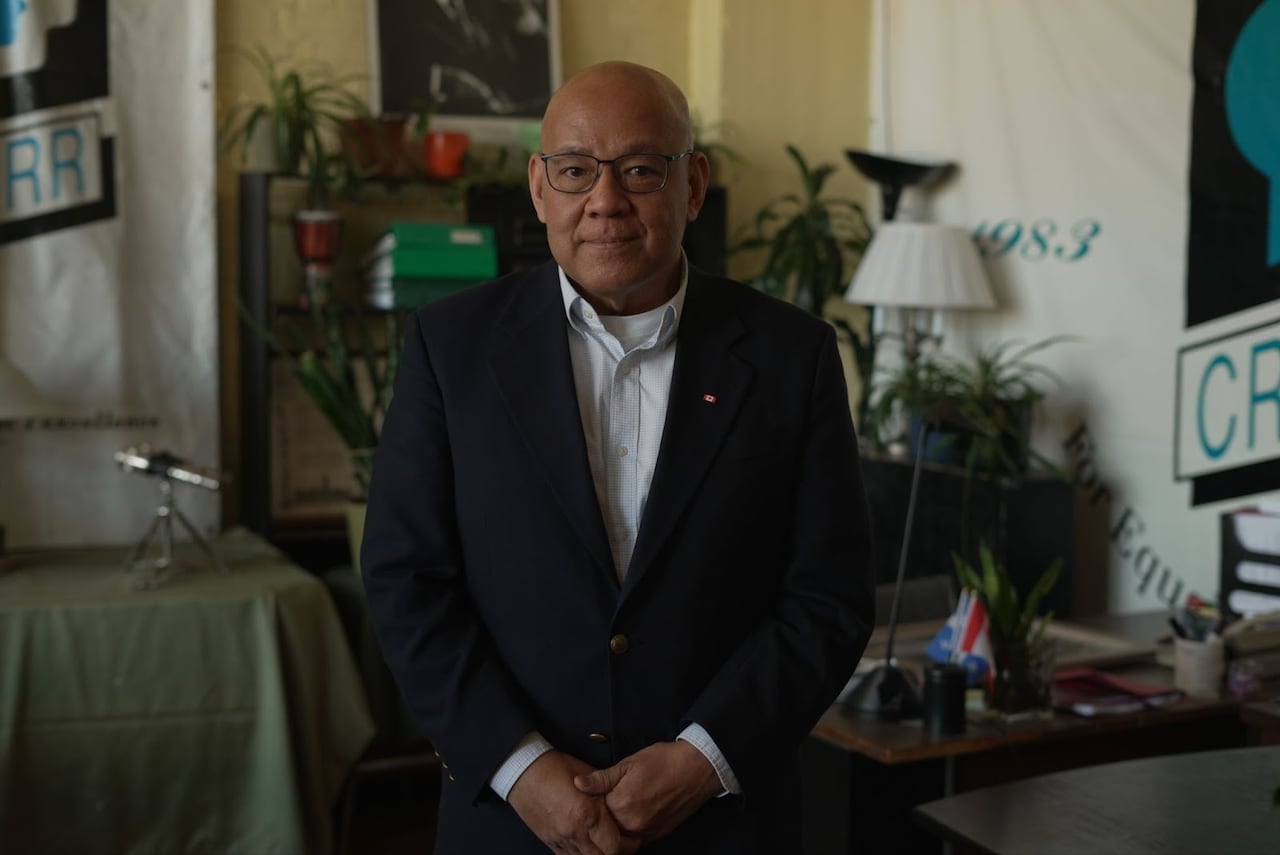 Man wearing dark jacket and Canada flag pin