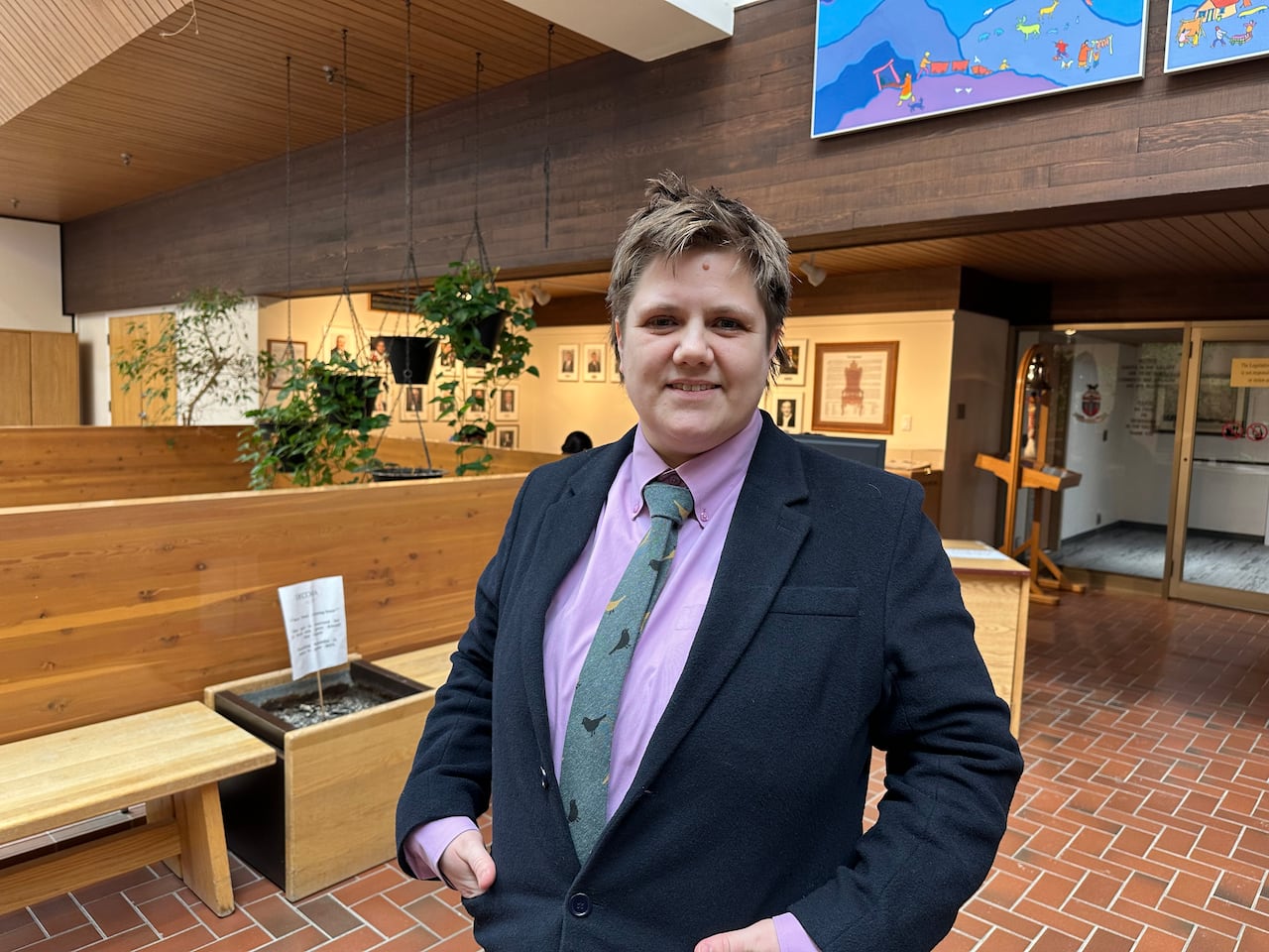 A person in a suit stands in the foyer of the legislative building on March 24, 2026. 