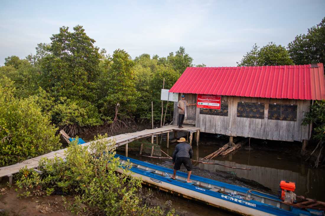 Khiev Sat and his son Khiev Chien ready a boat at a building managed by the Koh Kresna Lok Community Fishery in Cambodia.