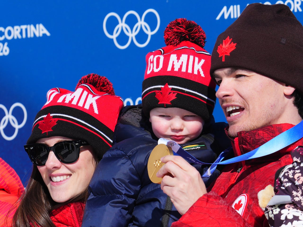 A man holds his son.