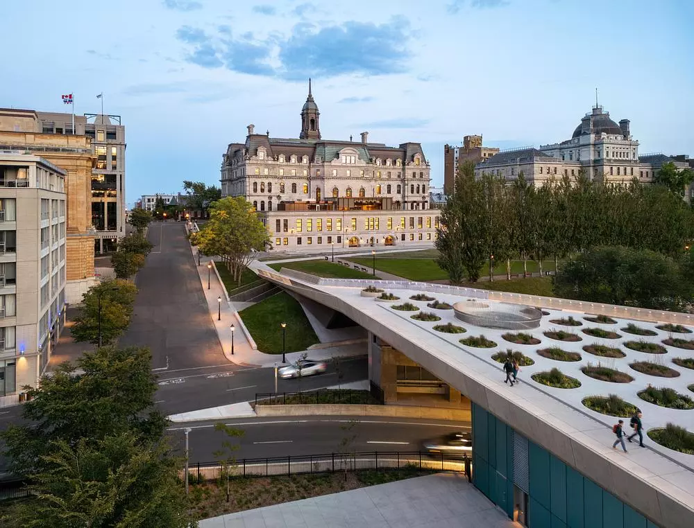 The urban forest at the northern edge provides a transition from street to plaza