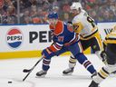 Connor McDavid (97) of the Edmonton Oilers, draws a hooking penalty on Sidney Crosby (87) of the Pittsburg Penguins at Rogers Place in Edmonton on  Thursday, January 22, 2026.