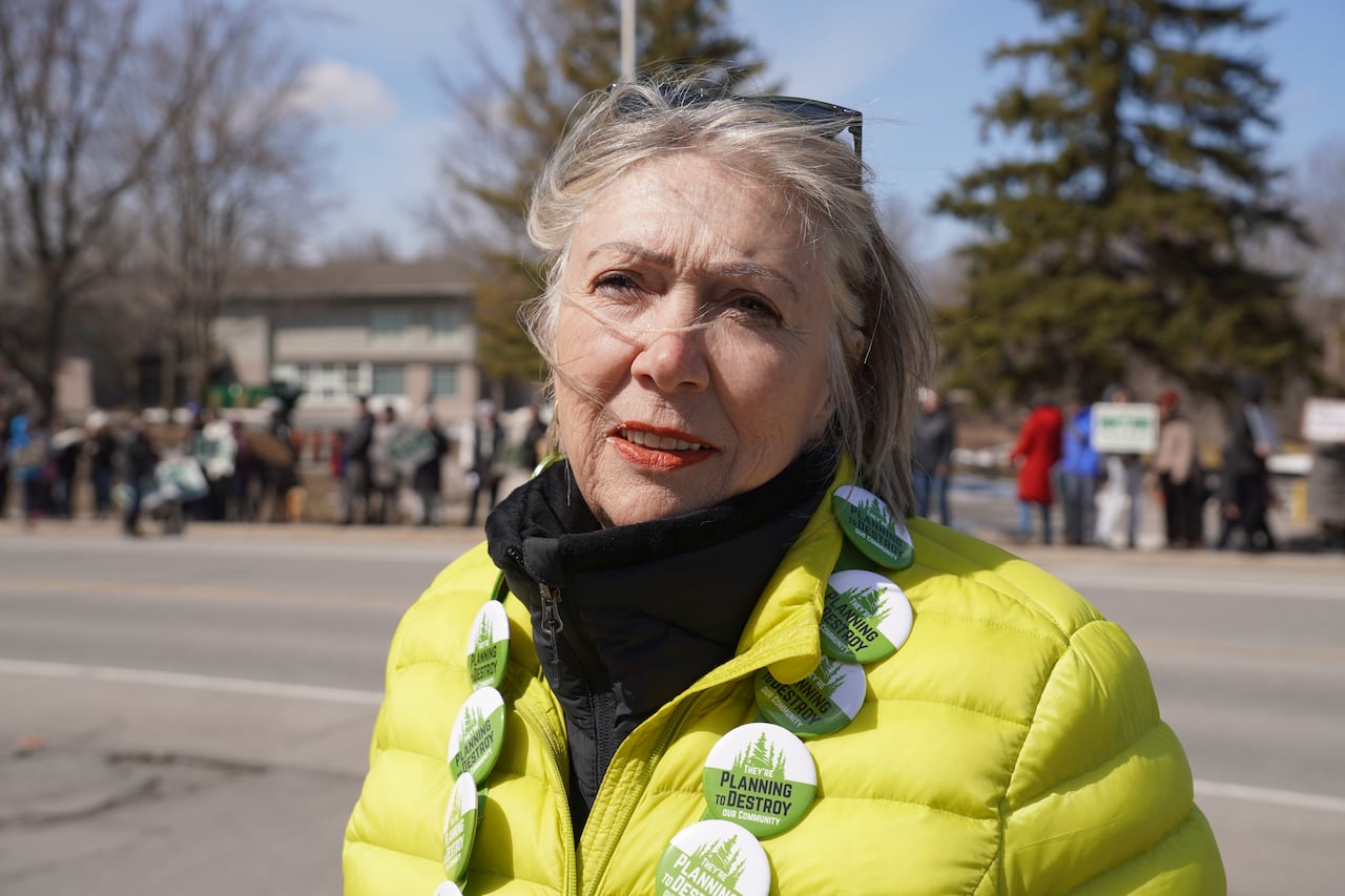 A photo of a woman wearing a green jacket.