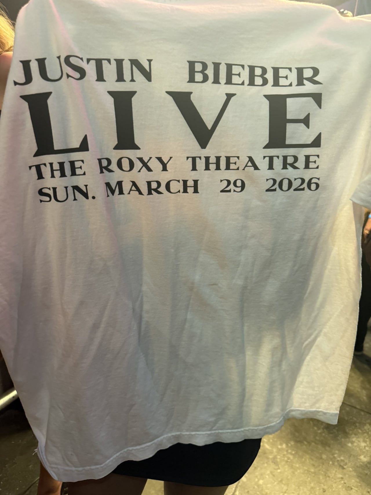 A white t-shirt that reads Justin Bieber Live The Roxy Theatre Sun. March 29 2026