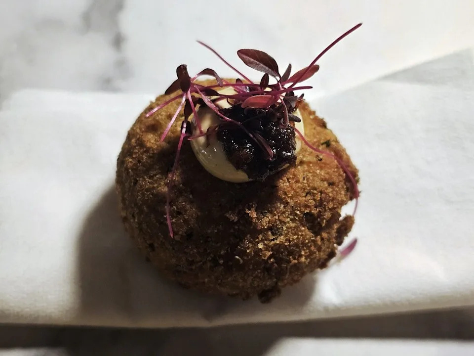 Jollof arancini by Ifeoluwa Oluwaolubode of Afro Snack Bar, filled with spiced rice and topped with a fiery Ghanaian chili paste and cool lime aioli.