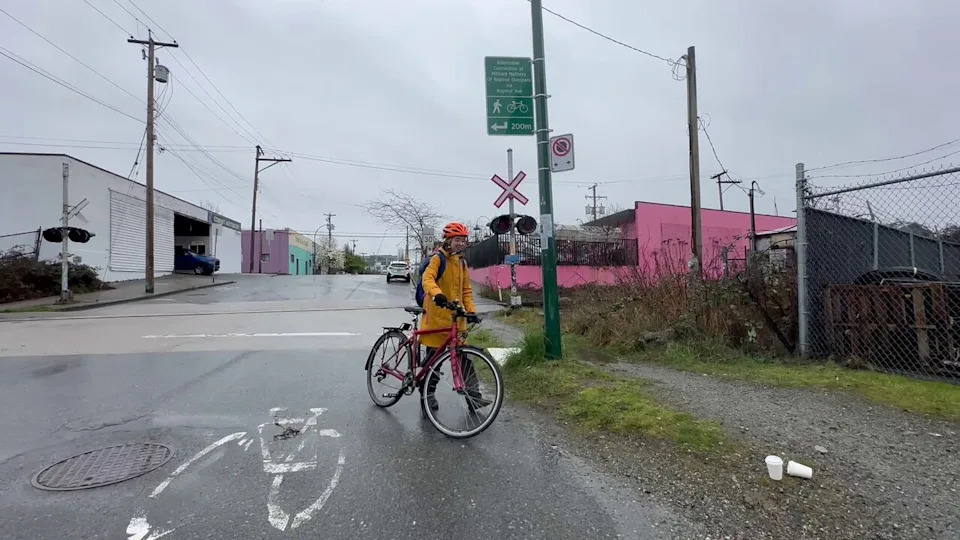 Griffin walks past where the boot first flew out of 'Cinderfella's bike carrier on the Adanac Bikeway.