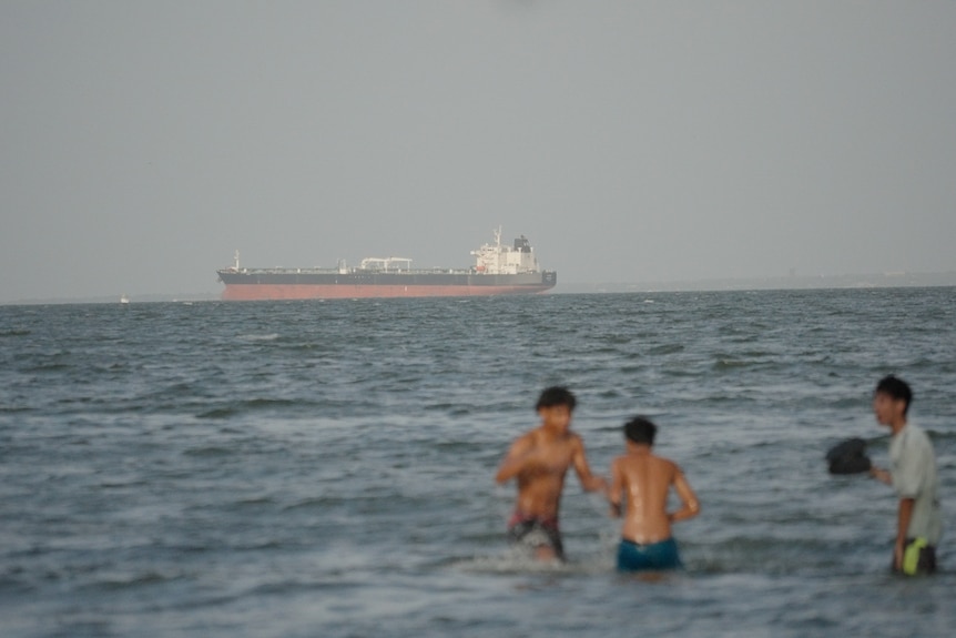 Boys playing in a lake.
