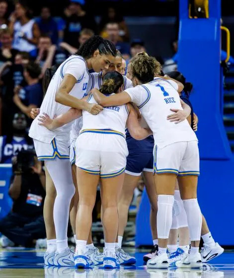 UCLA center Lauren Betts and teammates huddle during an NCAA tournament game against California Baptist on Saturday.