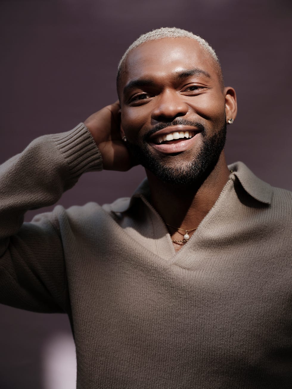 person wearing a stylish sweater with accessories