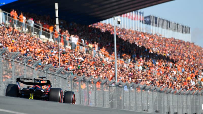 Max Verstappen (Red Bull-Honda) seen from behind in front of Orange Army fans during practice for the 2022 Dutch Grand Prix