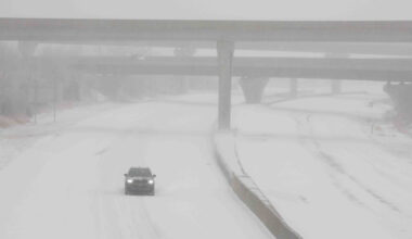 A vehicle travels westbound in blizzard conditions during a winter storm in Topeka