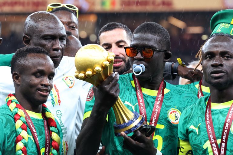 Soccer Football - CAF Africa Cup of Nations - Morocco 2025 - Final - Senegal v Morocco - Prince Moulay Abdellah Stadium, Rabat, Morocco - January 18, 2026 Senegal's El Hadji Malick Diouf celebrates with the trophy after winning the Africa Cup of Nations REUTERS/Amr Abdallah Dalsh