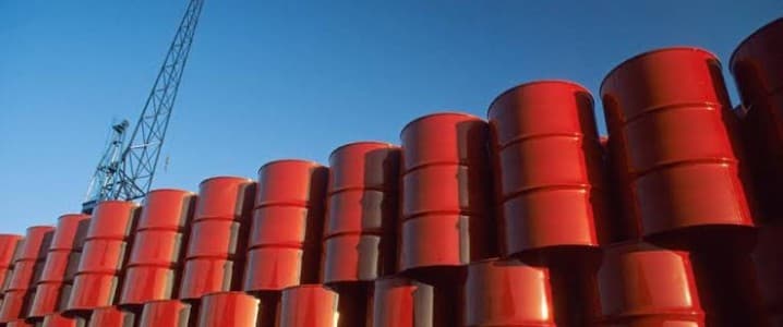 Stacked red oil barrels in a depository