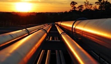A pipeline running into the distance with a sunset in the background.