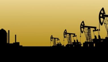 silhouette of oil rigs with a yellow background