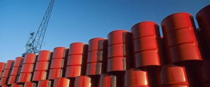 Stacked red oil barrels in a depository