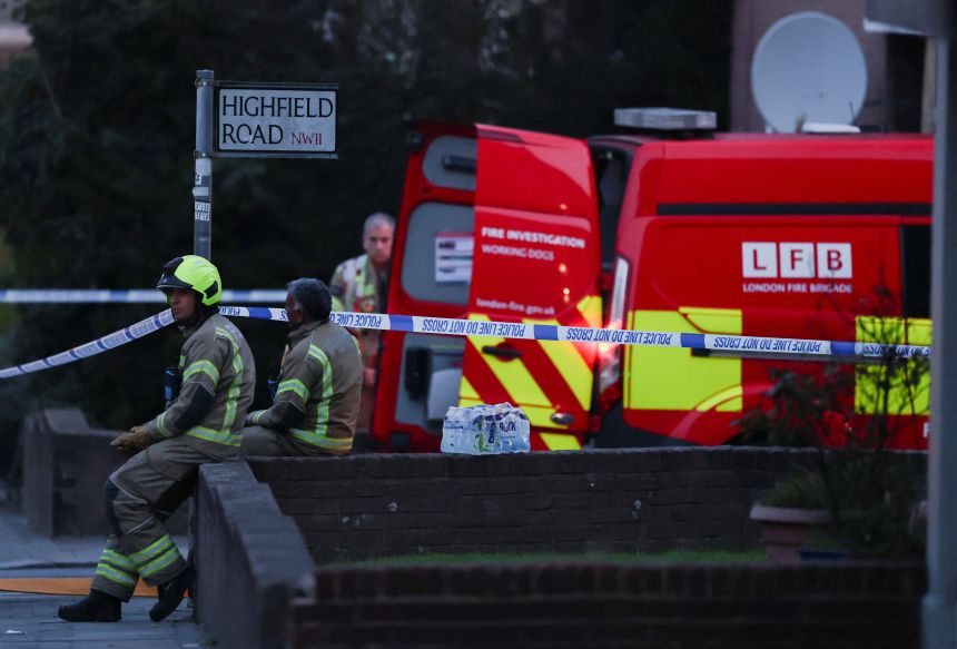 Firefighters gather at the scene after four ambulances belonging to Hatzola, a Jewish community organization, were set on fire in an incident that the police say is being treated as an antisemitic hate crime, in northwest London, on March 23, 2026.