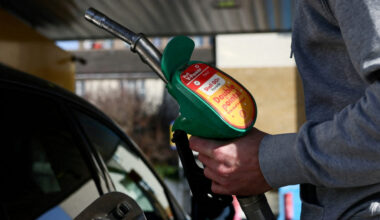 FILE PHOTO: A motorist returns the petrol pump after filling their car with fuel at a petrol station, as the price of oil ...