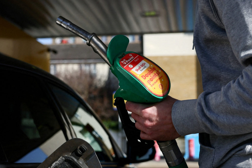 FILE PHOTO: A motorist returns the petrol pump after filling their car with fuel at a petrol station, as the price of oil ...