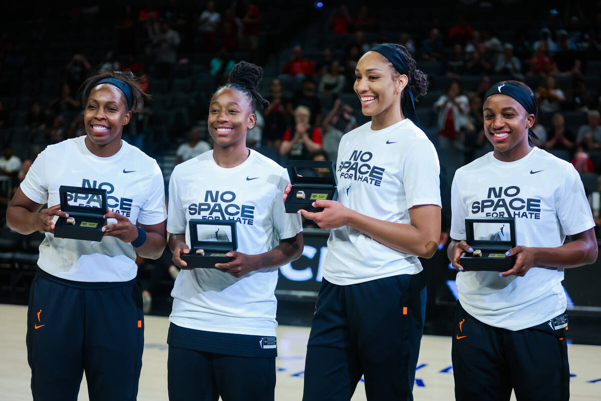 Aces teammates Chelsea Gray, from left, Jewell Loyd, A'ja Wilson and Jackie Young (0) are ...