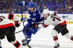 Curtis Douglas of the Tampa Bay Lightning eludes Ridly Greig of the Ottawa Senators during second period on Oct. 9 in Tampa, Fla.