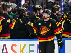 Filip Hronek of the Vancouver Canucks is congratulated at the players bench after scoring a goal during the second period against the Washington Capitals at Rogers Arena on Jan. 21, 2026.