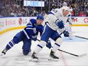 Jacob Quillan (26), of the Toronto Maple Leafs, battles with Darren Raddysh (43), of the Tampa Bay Lightning, in the second period at Scotiabank Arena on Saturday, March 7, 2026, in Toronto. 
