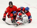 Auren Halbert #92 of Team Canada clashes with Alex Ohar #19 of Team Czechia and Filip Vesely #55 of Team Czechia during the Para Ice Hockey Preliminary Round Match between Team Canada and Team Czechia on day four of the Milano Cortina 2026 Winter Paralympic Games at Milano Santagiulia Ice Hockey Arena on March 10, 2026 in Milan, Italy.